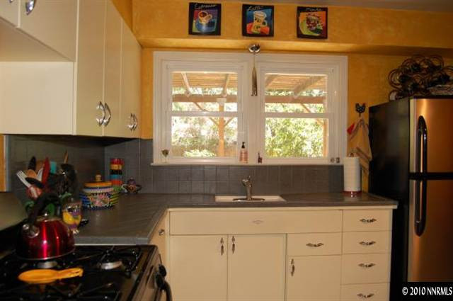 906 Bates Avenue Reno, NV 89502 - Photo 4 of 9 a kitchen with stainless steel appliances granite countertop a refrigerator and sink