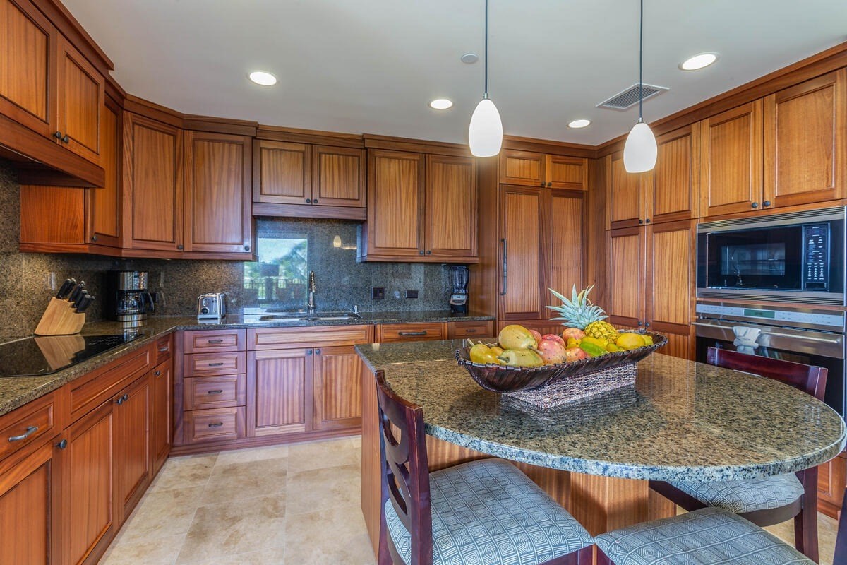 2641 Poipu Road, Unit 3201 Koloa, HI 96756 - Photo 3 of 12 a kitchen with stainless steel appliances granite countertop a stove a sink and a refrigerator