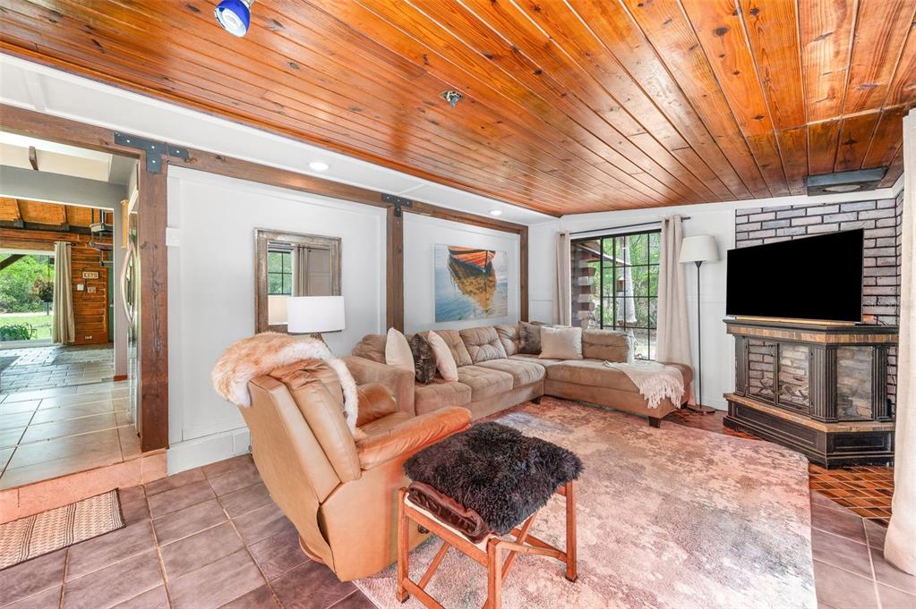 133 Seminole Trail Georgetown, FL 32139 - Photo 13 of 87 a living room with furniture a flat screen tv and a floor to ceiling window