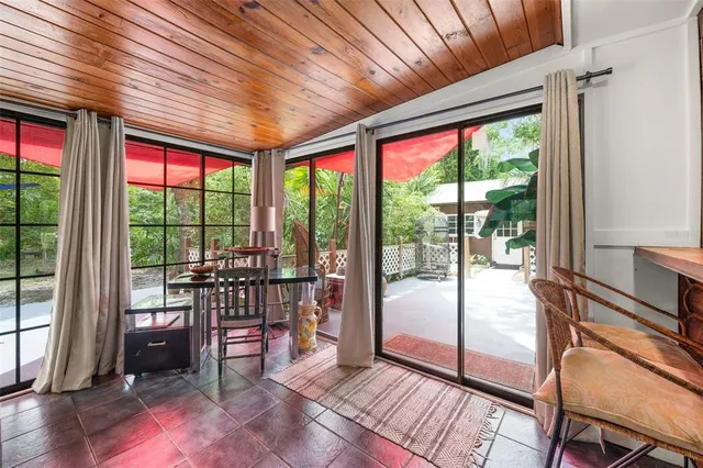 a view of a patio with chairs under an umbrella