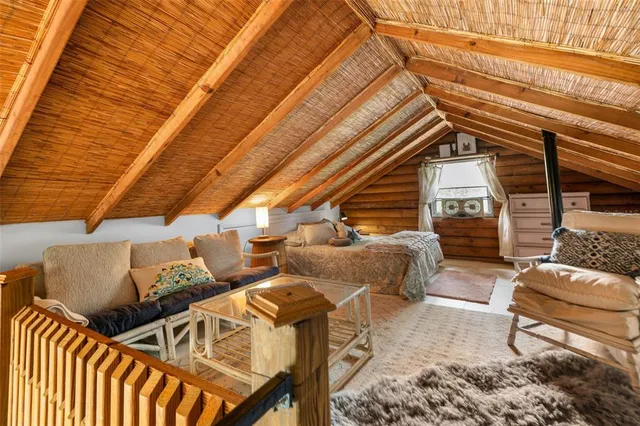 a view of a balcony with chairs and wooden floor