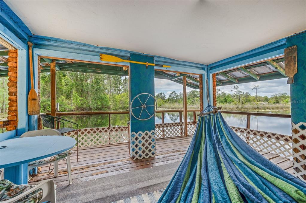 133 Seminole Trail Georgetown, FL 32139 - Photo 39 of 87 a view of a balcony with chairs and wooden floor