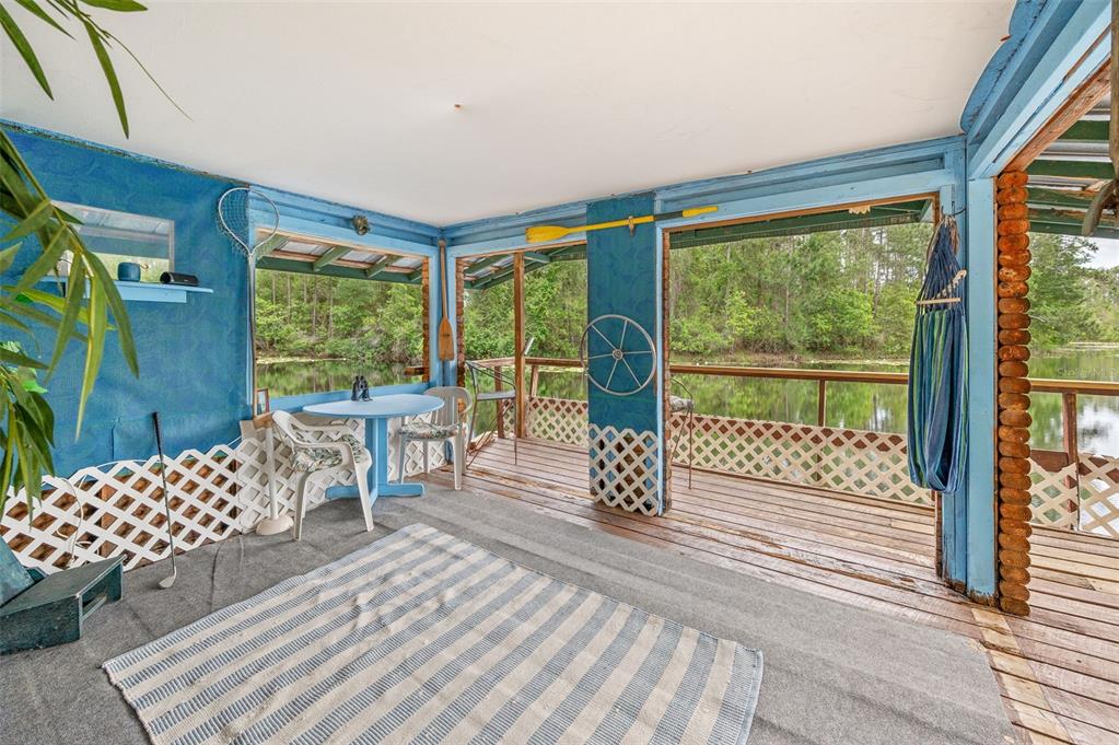 133 Seminole Trail Georgetown, FL 32139 - Photo 42 of 87 a living room with a floor to ceiling window and wooden floor