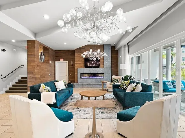 a living room with fireplace furniture and a chandelier
