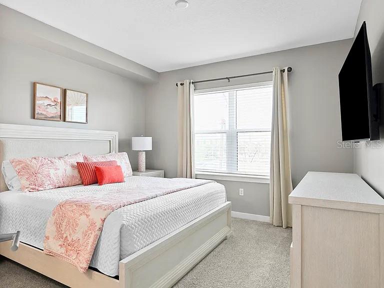 700 Cocoanut Avenue, Unit 331 Sarasota, FL 34236 - Photo 5 of 25 a bedroom with a bed and a flat screen tv