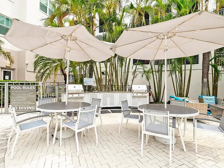 700 Cocoanut Avenue, Unit 331 Sarasota, FL 34236 - Photo 8 of 25 a view of patio with chairs and table under an umbrella