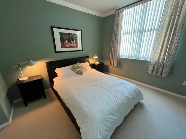 a bedroom with bed and window