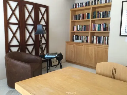 a bedroom with furniture and a book shelf