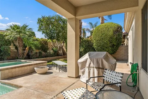 a view of a chairs and table in the patio