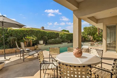 a terrace with outdoor seating and city view