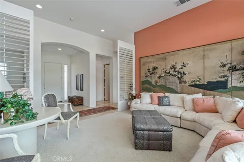 a living room with furniture and a potted plant