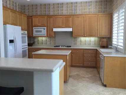 a kitchen with a sink a stove and a refrigerator
