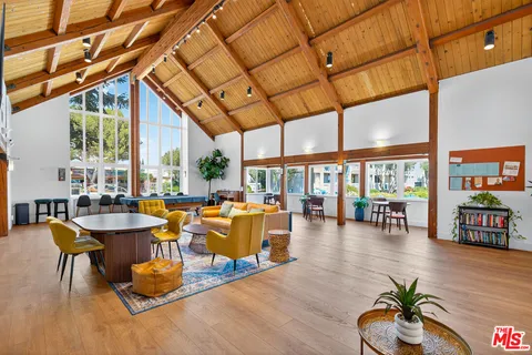 a living room with fireplace furniture and a large window