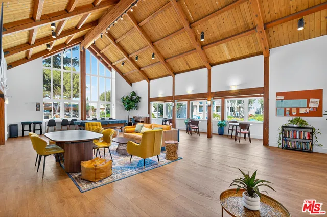 a living room with fireplace furniture and a large window