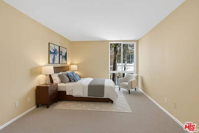 a bedroom with bed and a window