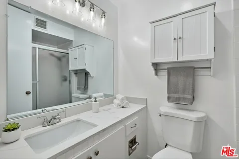 a bathroom with a sink double vanity and a mirror