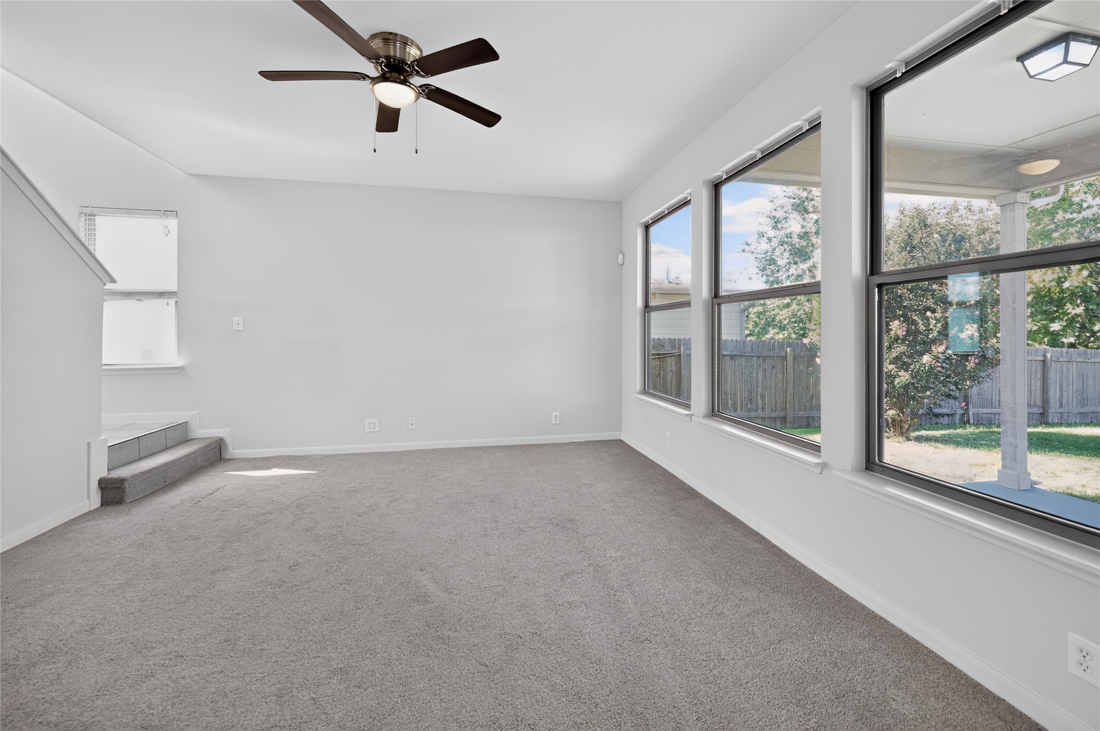 504 Old Peak Road Georgetown, TX 78626 - Photo 6 of 25 A spacious living area features soft carpeting, ample natural light, and convenient outdoor access.