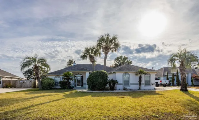 a front view of house with yard and swimming pool