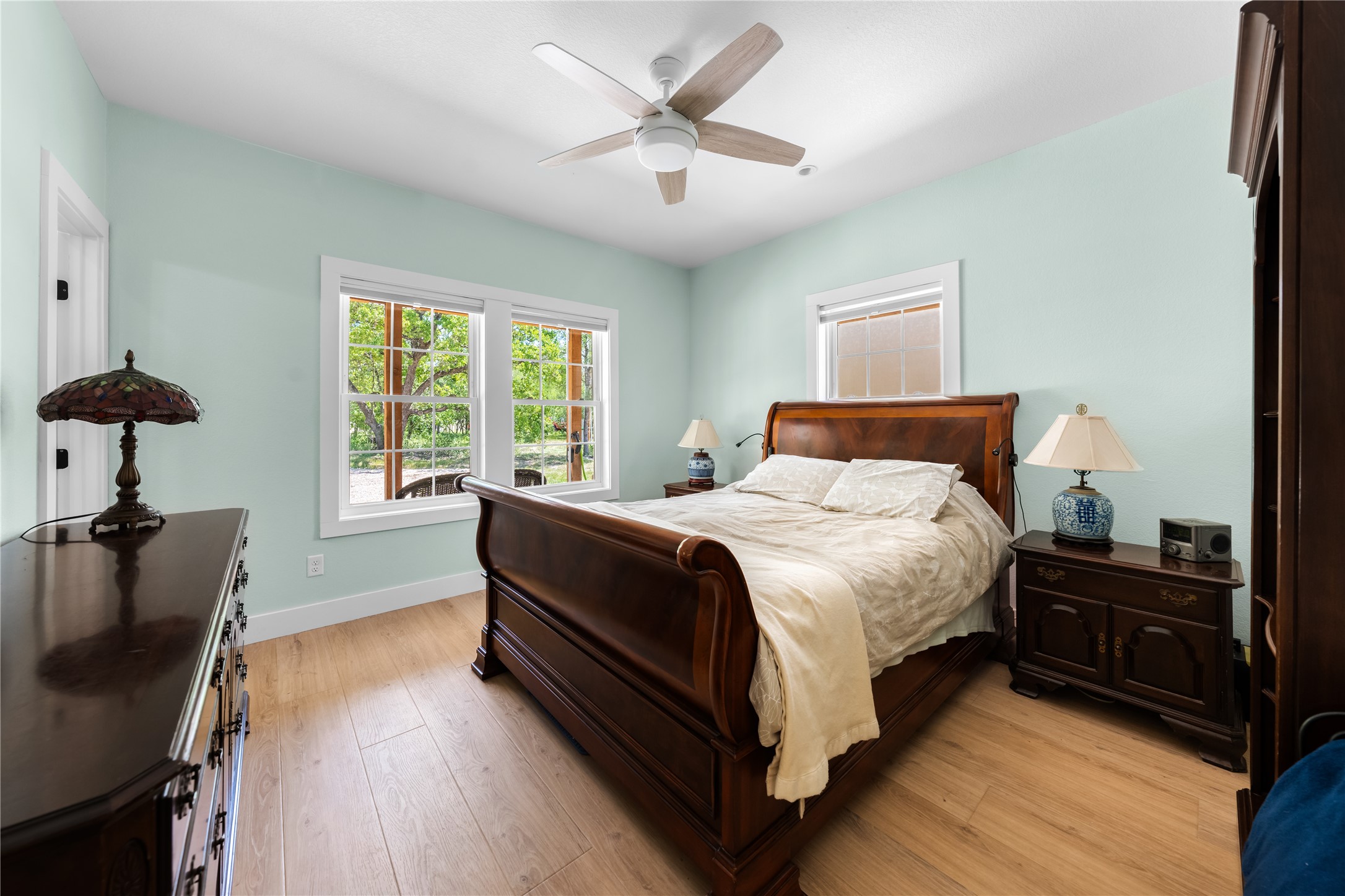 7670 Nez Perce Trace Manor, TX 78653 - Photo 26 of 40 Bedroom featuring baseboards, light wood-type flooring, and a ceiling fan