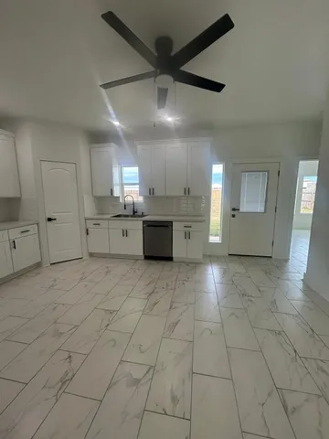 a large bathroom with a large tub shower and cabinets