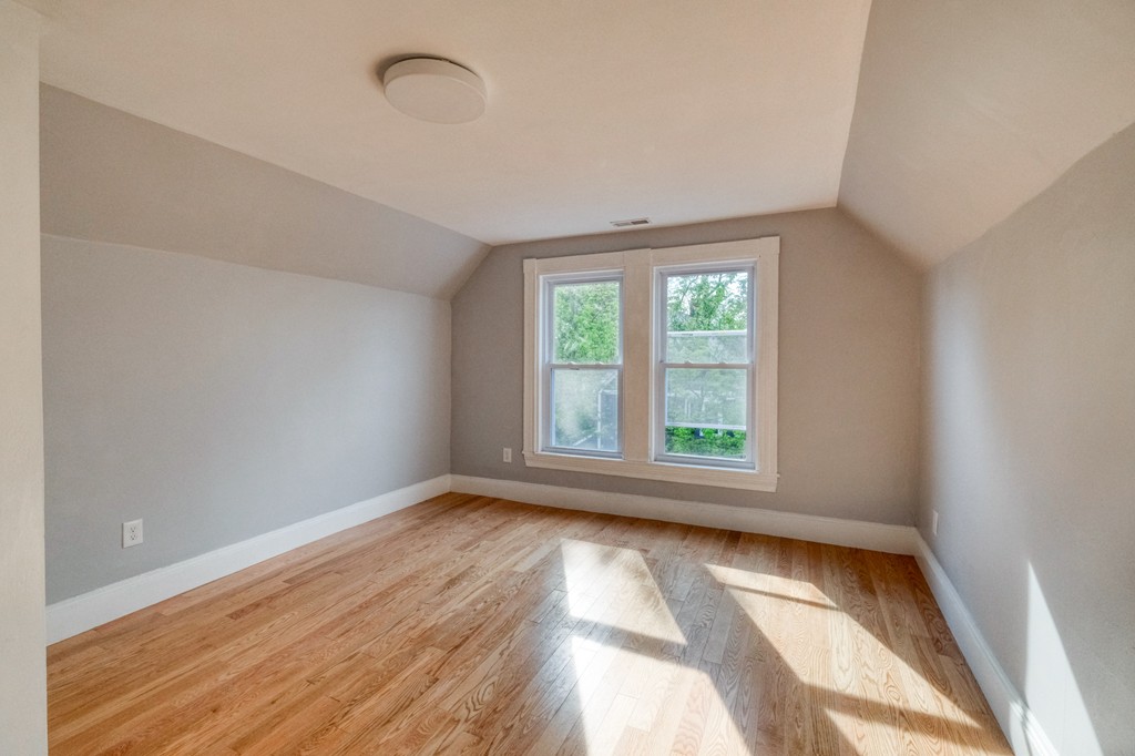 a view of room with window and hardwood floor