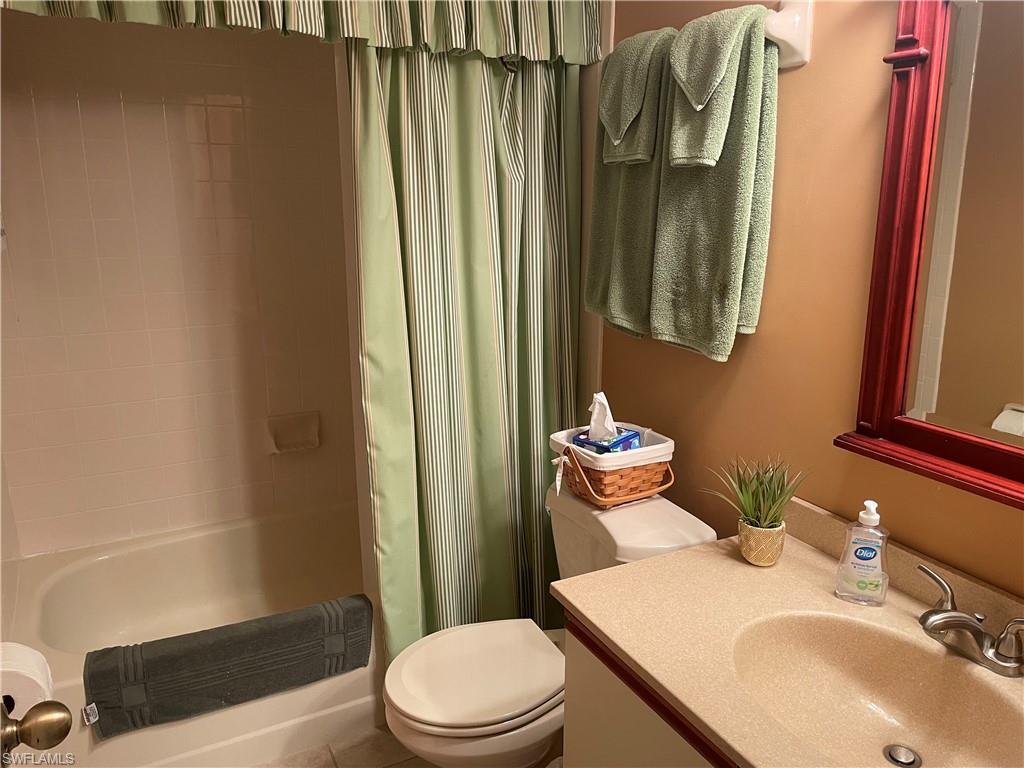 5970 Amherst Drive, Unit C103 Naples, FL 34112 - Photo 16 of 24 Full bathroom with vanity and shower / bath combination with curtain
