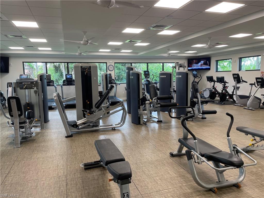5970 Amherst Drive, Unit C103 Naples, FL 34112 - Photo 21 of 24 Exercise room with a drop ceiling, healthy amount of natural light, and a ceiling fan