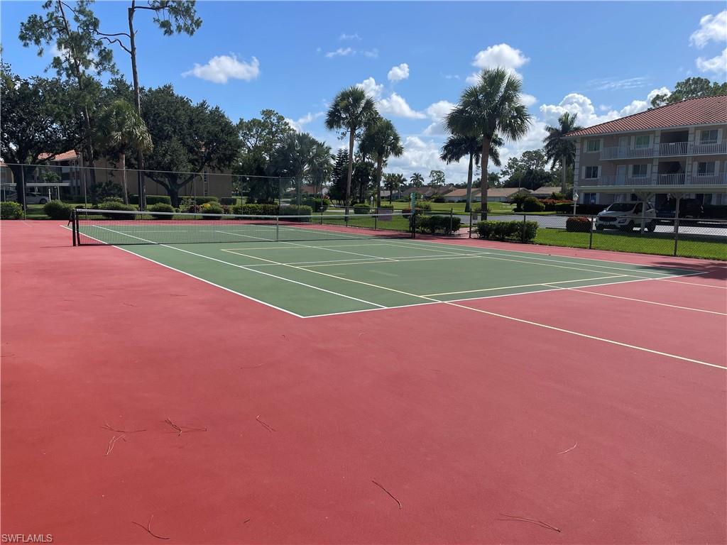 5970 Amherst Drive, Unit C103 Naples, FL 34112 - Photo 22 of 24 View of tennis court with community basketball court