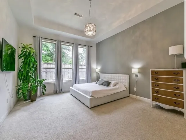 a spacious bedroom with a bed and a window