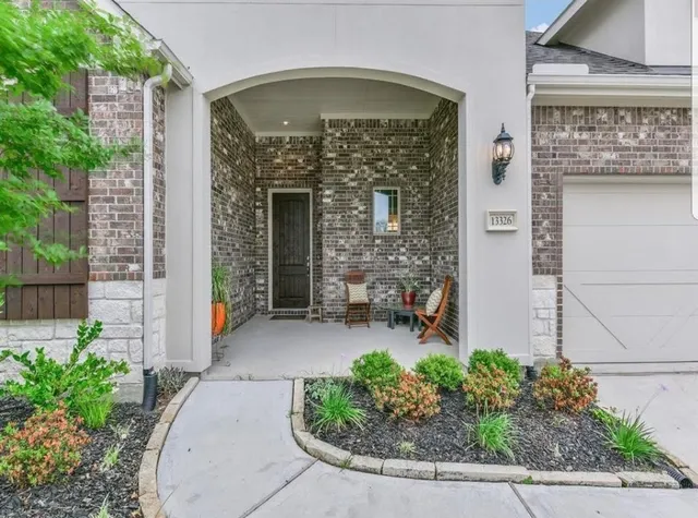 front view of a house with potted plants