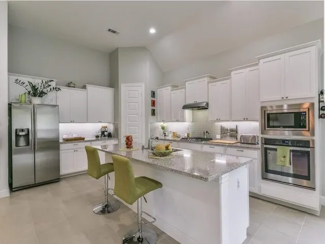 a kitchen with a sink stainless steel appliances and cabinets