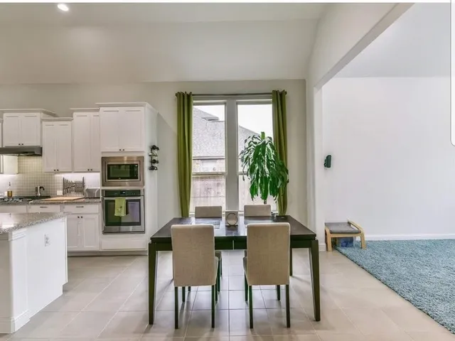 a dining room with furniture and window