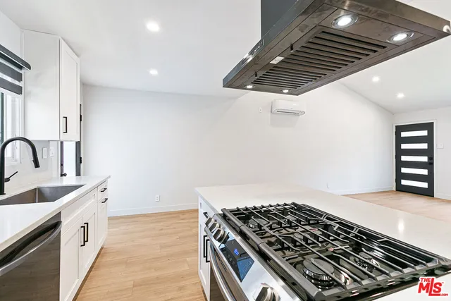 a kitchen with stove and cabinets