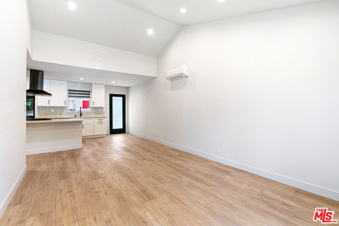 10420 Regent Street, Unit 10424 Los Angeles, CA 90034 - Photo 5 of 12 a view of a room with wooden floor and kitchen view