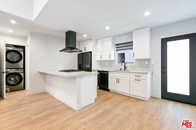 a kitchen with a stove top oven and cabinets