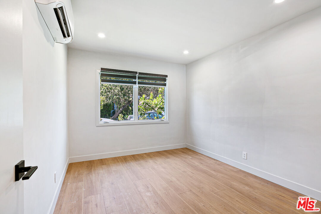 10420 Regent Street, Unit 10424 Los Angeles, CA 90034 - Photo 10 of 12 an empty room with wooden floor and windows