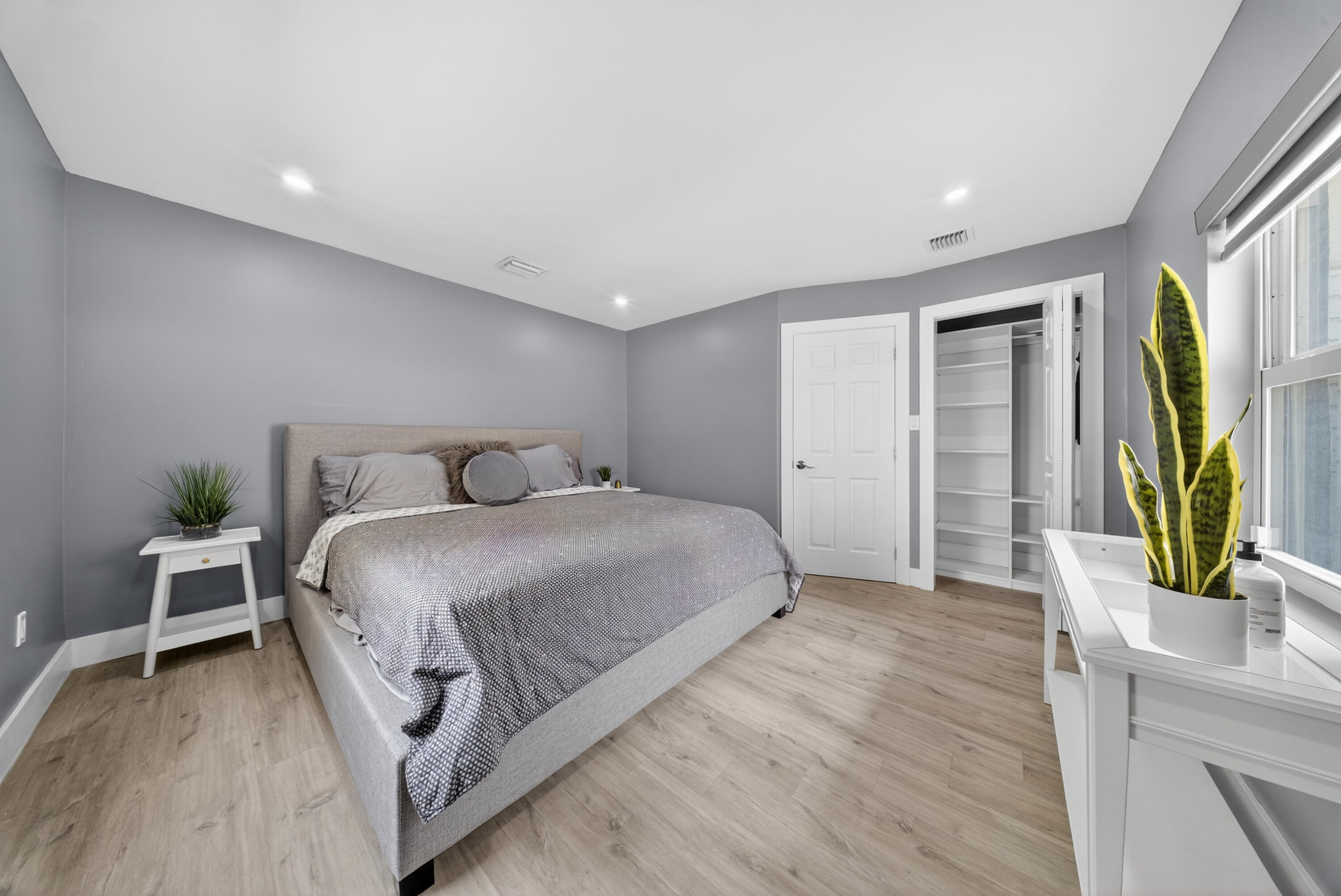 801 Southeast 15th Street Stuart, FL 34994 - Photo 12 of 25 a bedroom with a bed and a wooden floor