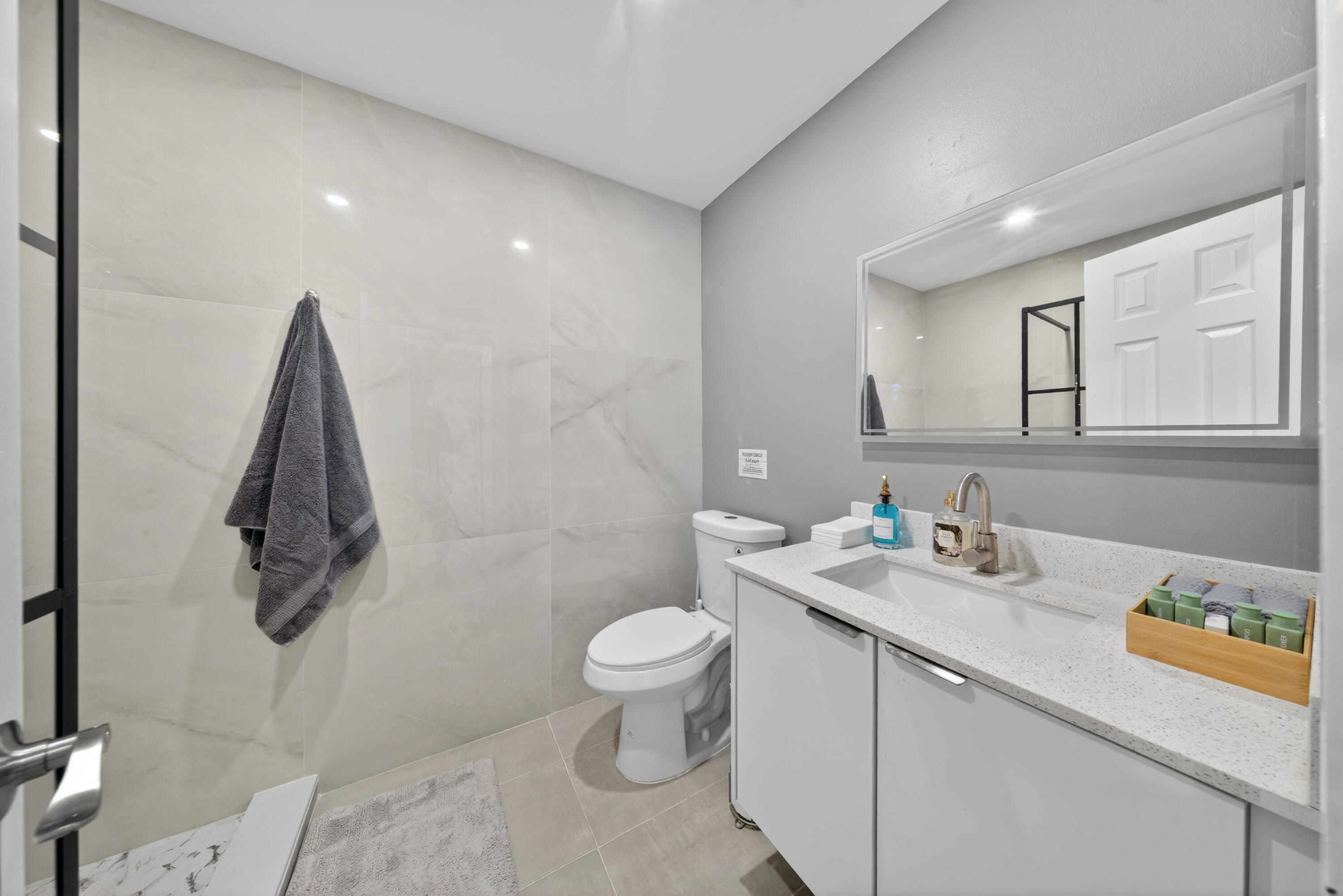 801 Southeast 15th Street Stuart, FL 34994 - Photo 13 of 25 a bathroom with a granite countertop sink a toilet and a mirror