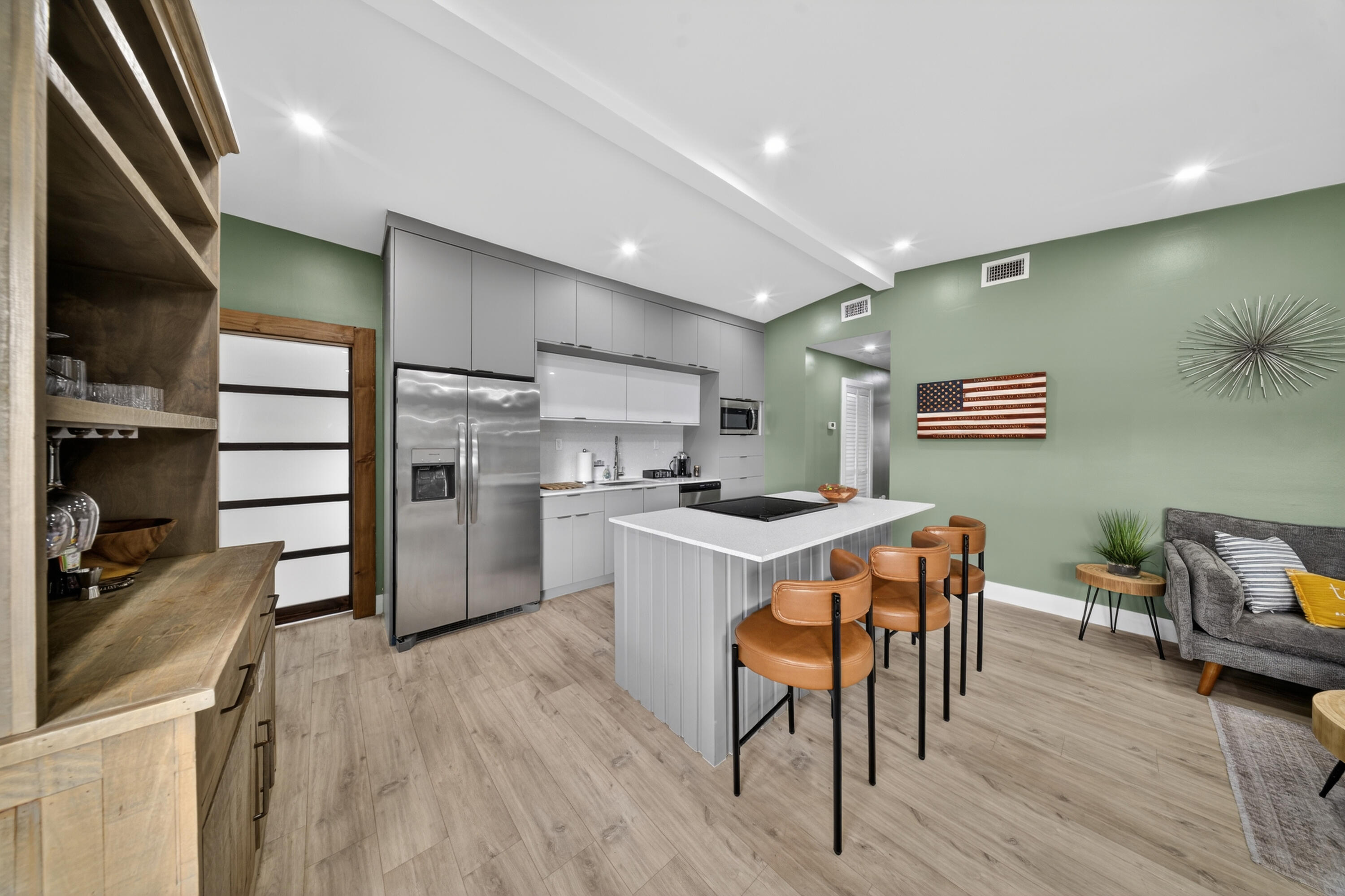 801 Southeast 15th Street Stuart, FL 34994 - Photo 2 of 25 a kitchen with kitchen island a wooden floor and chairs