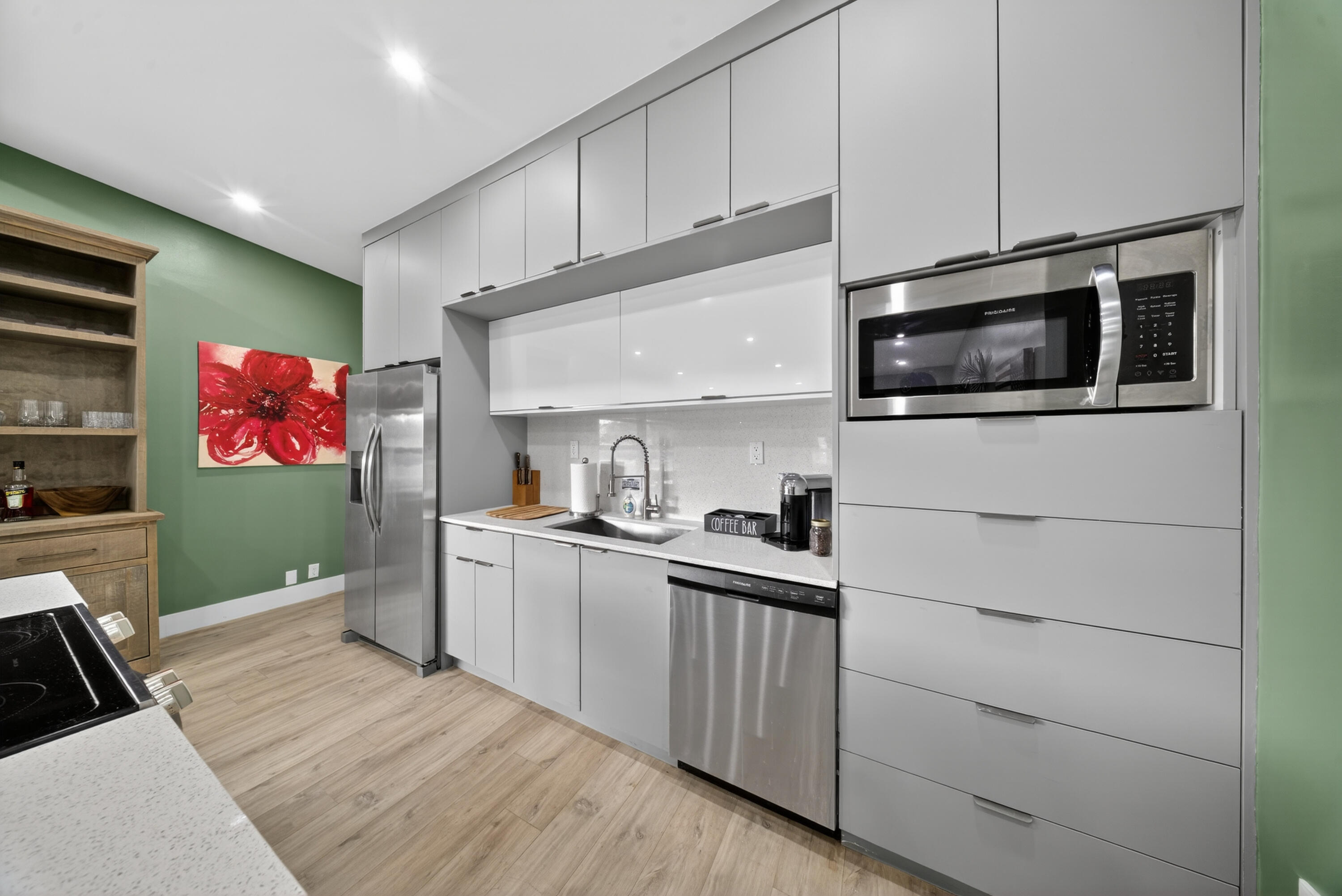 801 Southeast 15th Street Stuart, FL 34994 - Photo 7 of 25 a kitchen with granite countertop cabinets stainless steel appliances and wooden floor