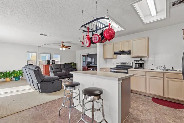 a kitchen with stainless steel appliances granite countertop a sink refrigerator and microwave