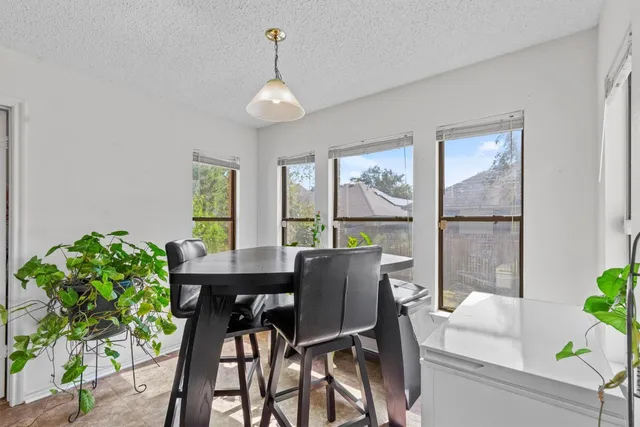 a kitchen with a table and chairs in it