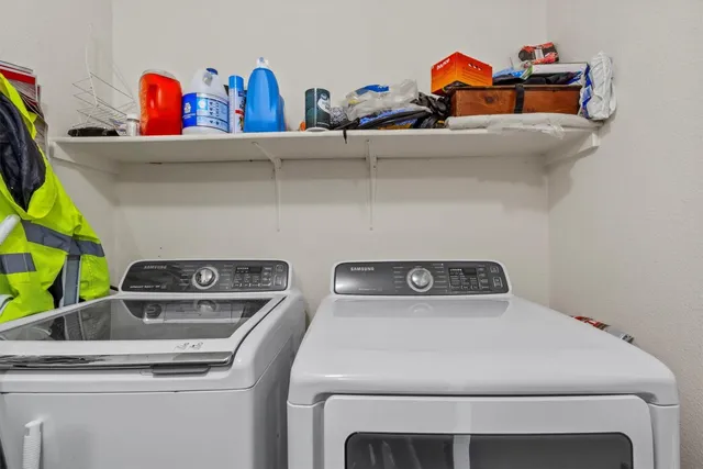 a view of an empty room with a chandelier fan