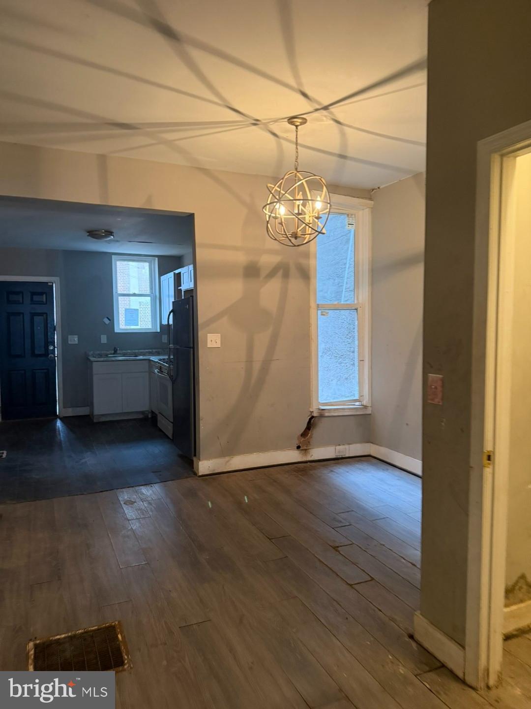 1409 East Lanvale Street Baltimore, MD 21213 - Photo 6 of 25 a view of livingroom with hardwood floor and kitchen view