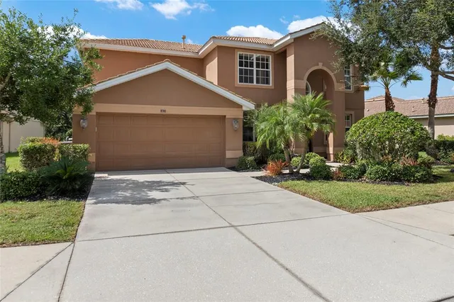 a front view of a house with a yard and garage