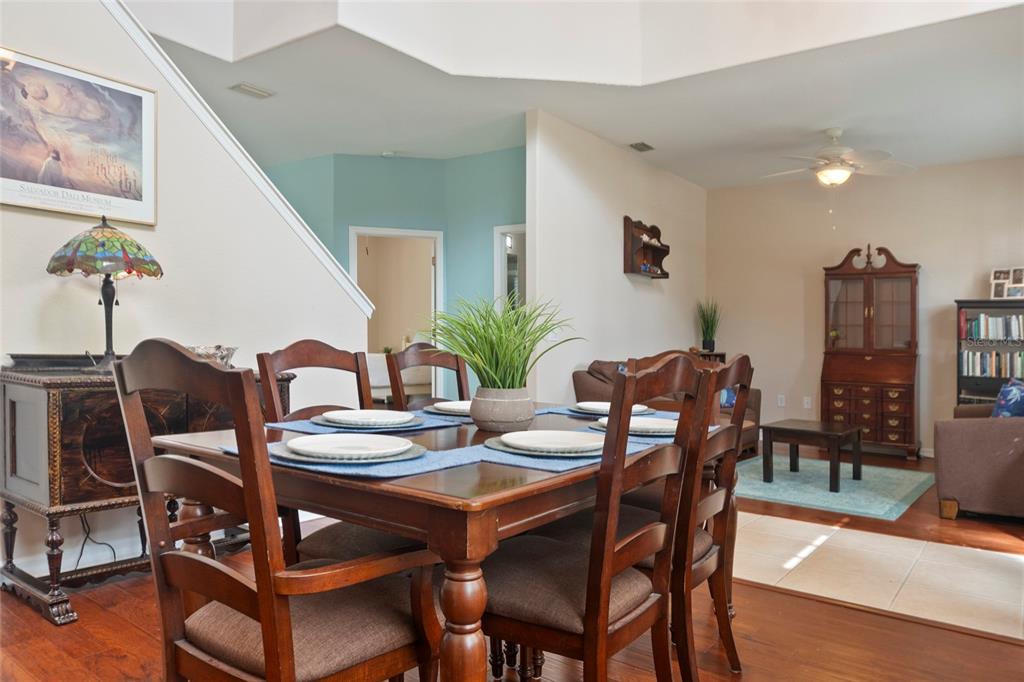 8746 Stone Harbour Loop Bradenton, FL 34212 - Photo 11 of 71 a view of a dining room with furniture and wooden floor