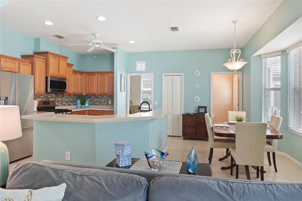8746 Stone Harbour Loop Bradenton, FL 34212 - Photo 16 of 71 a living room with kitchen furniture and a wooden floor
