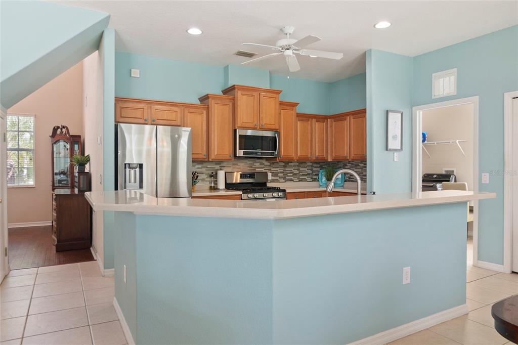 8746 Stone Harbour Loop Bradenton, FL 34212 - Photo 20 of 71 a kitchen with stainless steel appliances granite countertop a sink a stove a refrigerator and cabinets