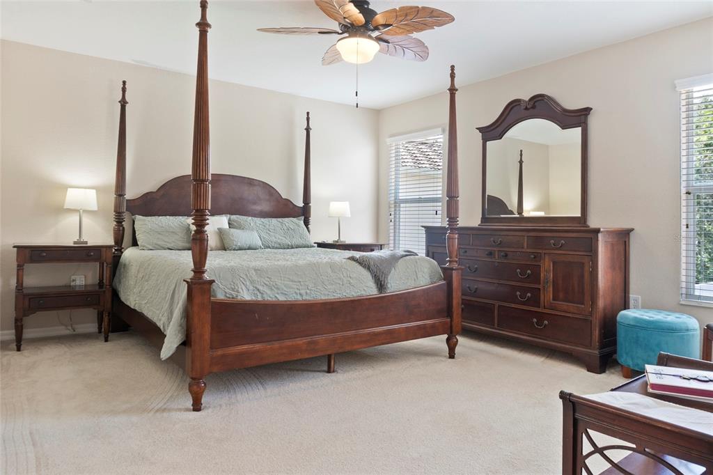 8746 Stone Harbour Loop Bradenton, FL 34212 - Photo 31 of 71 a bedroom with a bed chandelier and a window