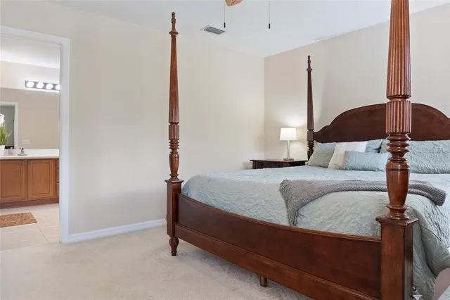 a bedroom with a bed and a table